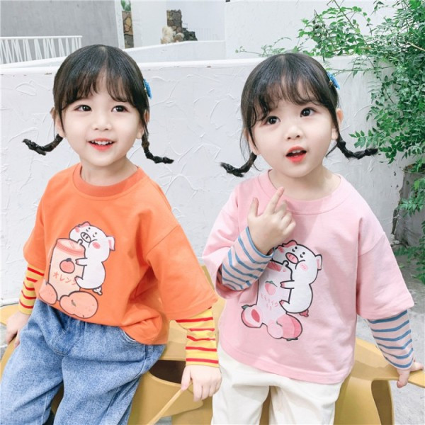 Laisva vaikiška palaidinė su aplikacijomis ir apvalia iškirpte mergaitėms