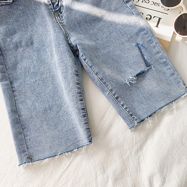 Női nadrág 3/4 hosszban, szakadt motívumokkal, két színben