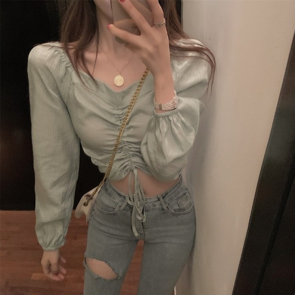 Lühike naiste pluus, millel on volditud esiosa ja lipsud