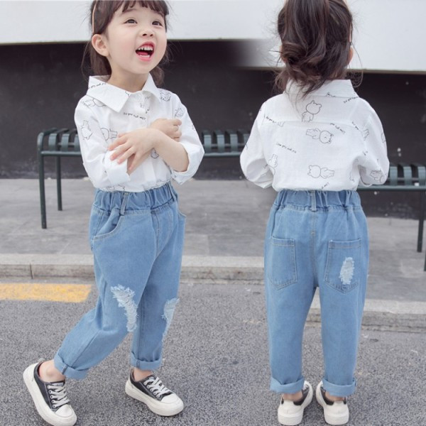 Bērnu džinsi ar kabatām un saplēstiem motīviem meitenēm