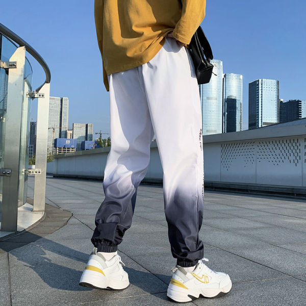 Ikdienas vīriešu bikses ar uzrakstu zaigojošās krāsās