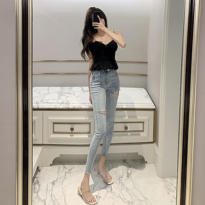 Lengvi moteriški džinsai Lieknas modelis aukštu liemeniu ir suplėšytais motyvais