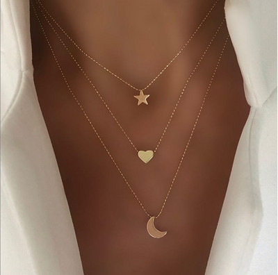 Women`s necklace in three rows with star, moon and heart pendants
