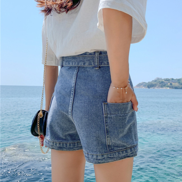 Modern női rövid farmernadrág zsebekkel, magas derékkal és övvel