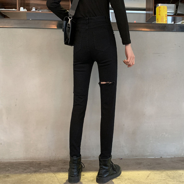 Modern női hosszú farmer szakadt motívummal, magas derékkal