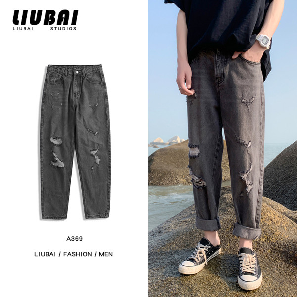 Modern férfi farmer szakadt motívummal széles modellel