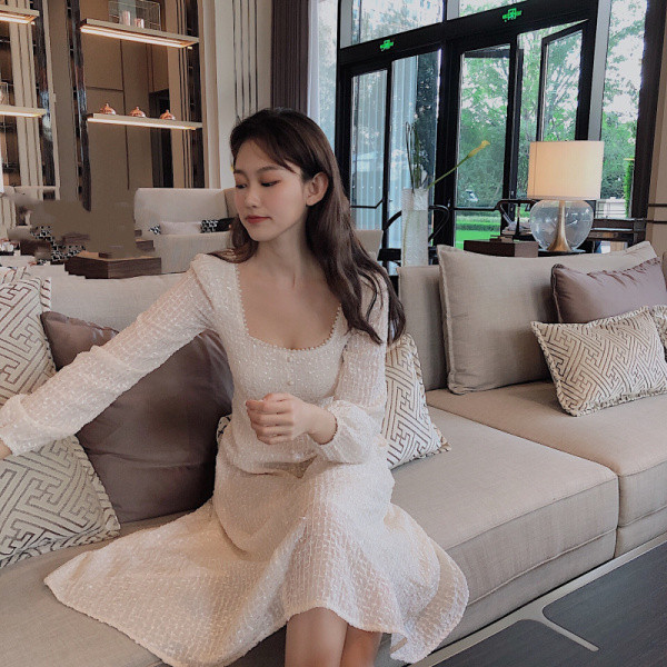 Balta sieviešu kleita ar kvadrātveida kakla izgriezumu un pogām