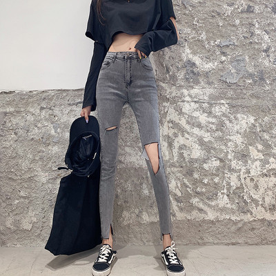 Moderns sieviešu džinsu modelis ar augstu vidukli un saplēstiem motīviem