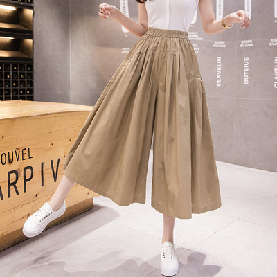 Széles női nadrág magas derékkal és zsebekkel