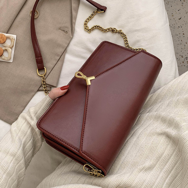 Moderni moteriška rankinė su metaliniu užsegimu ir ilga rankena