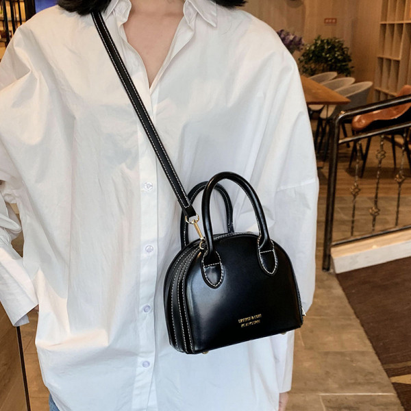 Moderna ženska torba s patentnim zatvaračem te dugom i kratkom ručkom