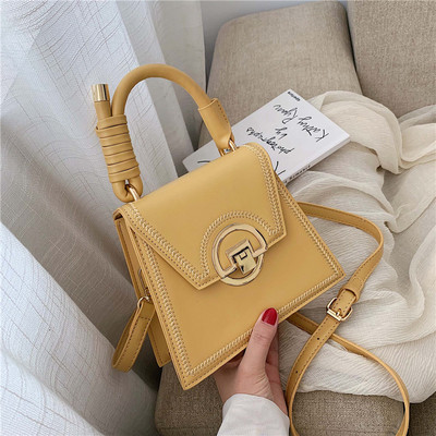 Moderna sieviešu soma ar metāla aizdari un garu un īsu ādas rokturi