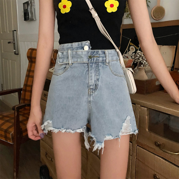 Kõrge vöökoha ja rebenenud motiividega heledad teksapüksid