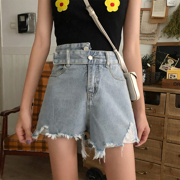 Kõrge vöökoha ja rebenenud motiividega heledad teksapüksid