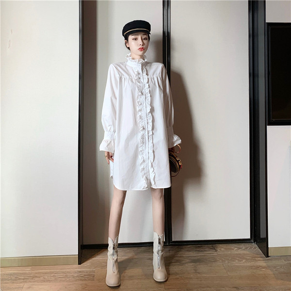 Széles női ruha fürtökkel és magas gallérral