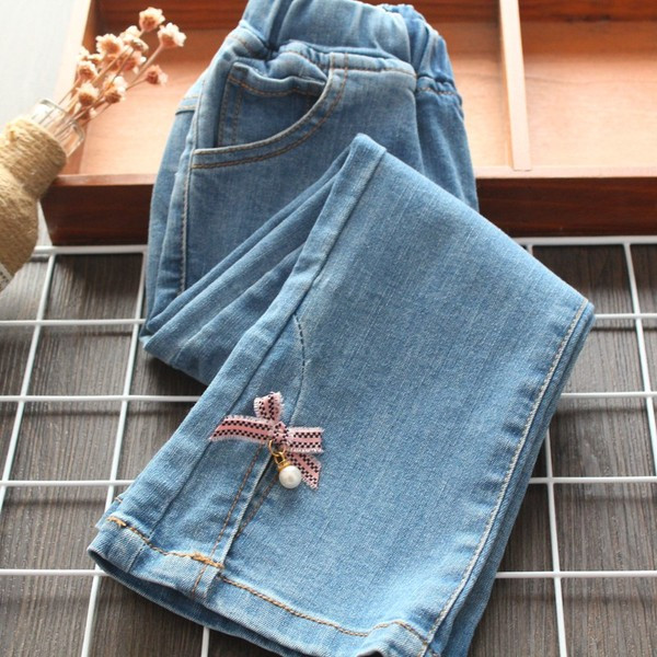 Mūsdienīgi bērnu džinsi ar lentīti un pērlēm meitenēm