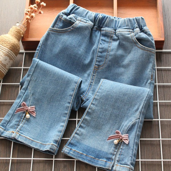 Mūsdienīgi bērnu džinsi ar lentīti un pērlēm meitenēm
