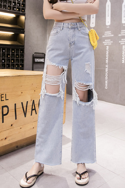 Széles női farmer magas derékkal, szakadt motívumokkal