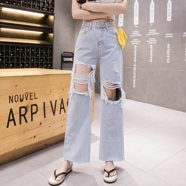 Széles női farmer magas derékkal, szakadt motívumokkal