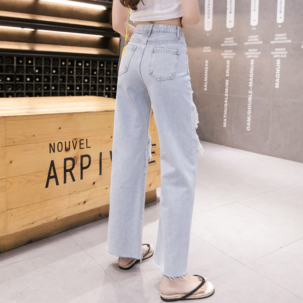 Széles női farmer magas derékkal, szakadt motívumokkal