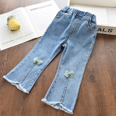 Mūsdienīgi bērnu džinsi meitenēm ar lentīti un saplēstiem motīviem