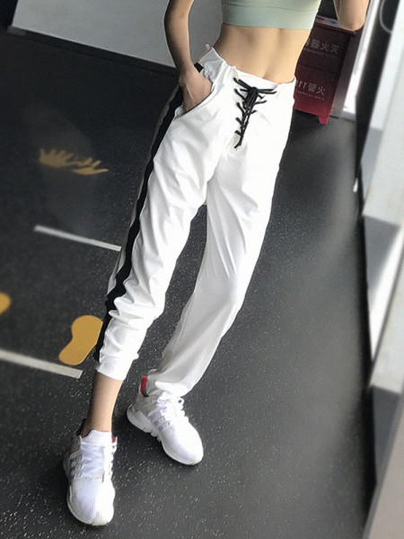 Női sportnadrág magas derékkal, oldalsó szegéllyel és megkötővel