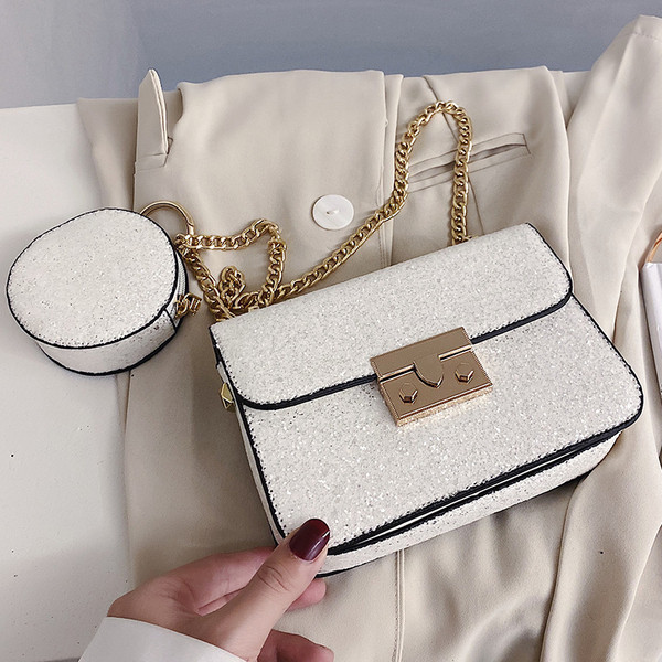 Stilinga rankinė su blizgiomis dalelėmis ir metaliniu užsegimu