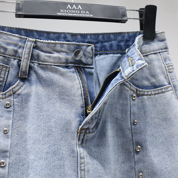 Modernus moteriškas sijonas su metaliniais elementais ir plėšytais motyvais