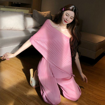 Modernus moteriškas asimetriškos palaidinės ir ilgų kelnių komplektas