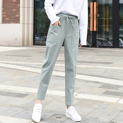 Ležerne ženske hlače ravnog modela s vezicama i džepovima