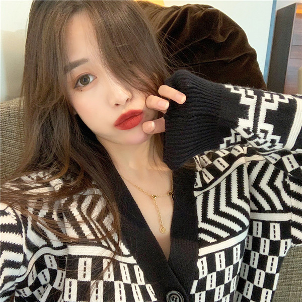 Fekete-fehér női mellény spitz nyakkivágással és gombokkal