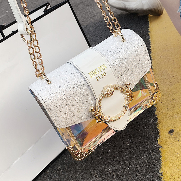 Stílusos női táska fém díszítéssel és fényes részecskékkel