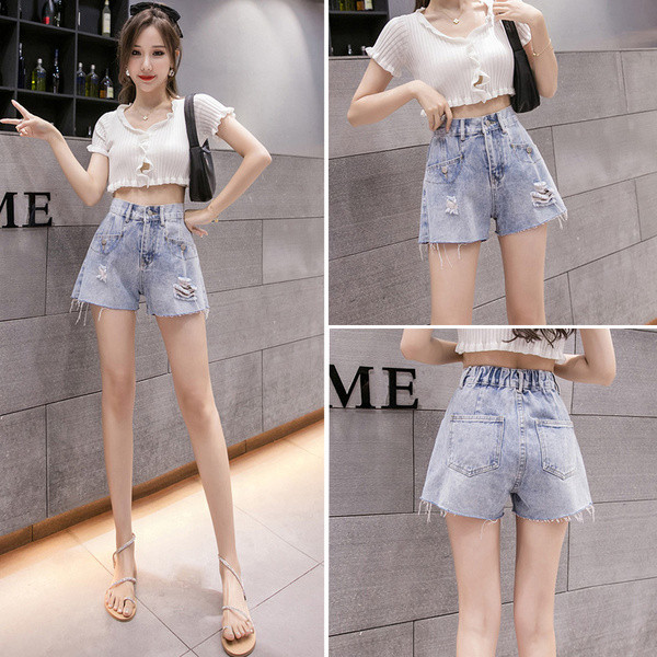 Moodsad teksapüksid elastse vöökoha ja rebenenud elementidega