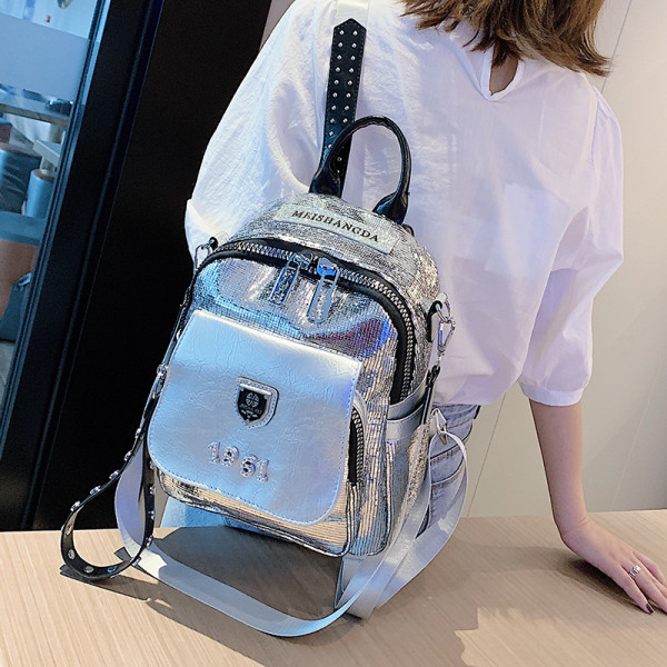 Moodne naiste seljakott kirja ja läikiva efektiga