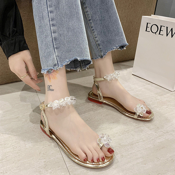 Modernas sieviešu sandales ar zemām zolēm un elementiem-akmeņiem