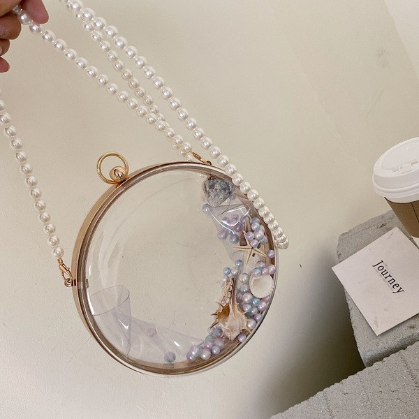 Átlátszó női táska gyöngyökkel és kerek formával