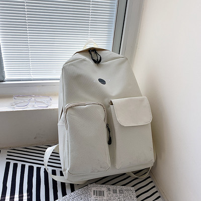 Sieviešu ikdienas mugursomas plats modelis ar kabatām priekšpusē