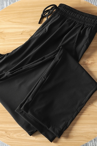 Meeste mustad vabaaja püksid kummikuga