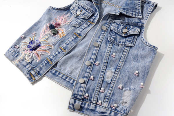 Moderna sieviešu īsā veste ar pērlēm un 3D elementu