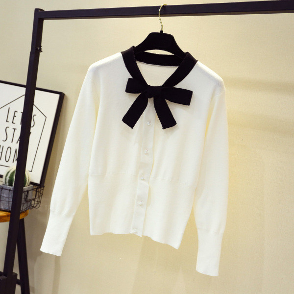 Moderna sieviešu veste - ar lentīti un pogām