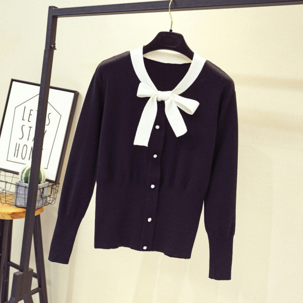 Moderna sieviešu veste - ar lentīti un pogām