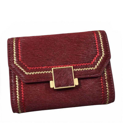 Naiste rahakott metallist kinnituse ja tikandiga