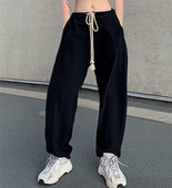 Női nadrág nyakkendővel, magas derékkal