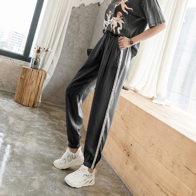 Divatos női nadrág fényes szegéllyel, magas derékkal