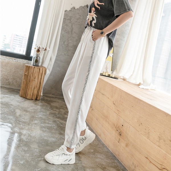 Divatos női nadrág fényes szegéllyel, magas derékkal