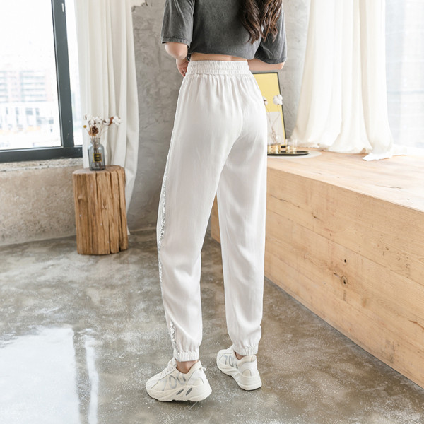 Divatos női nadrág fényes szegéllyel, magas derékkal