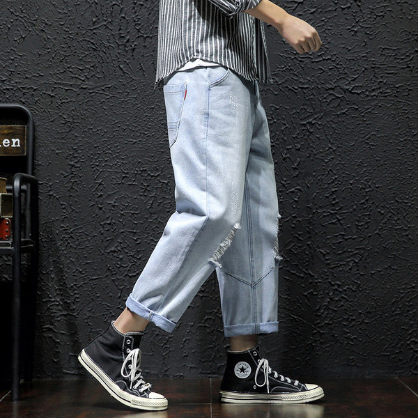 Lezser férfi hosszú farmer széles modell szakadt motívumokkal és cipzárral