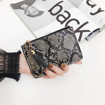 Aktuális női pénztárca kígyómintával és bojttal