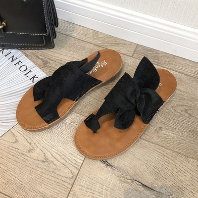 Modern női papucs lapos talppal, dekoratív csomóval