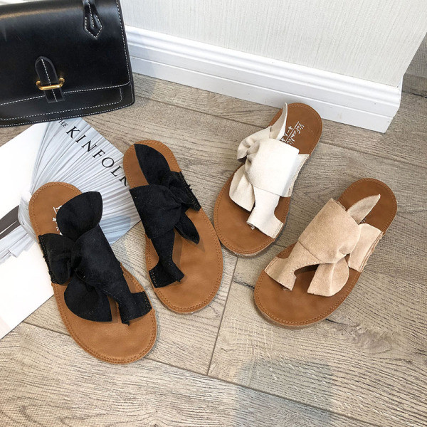 Modern női papucs lapos talppal, dekoratív csomóval